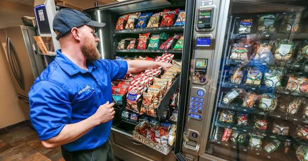 SoCal Vending route driver restocking a snack machine